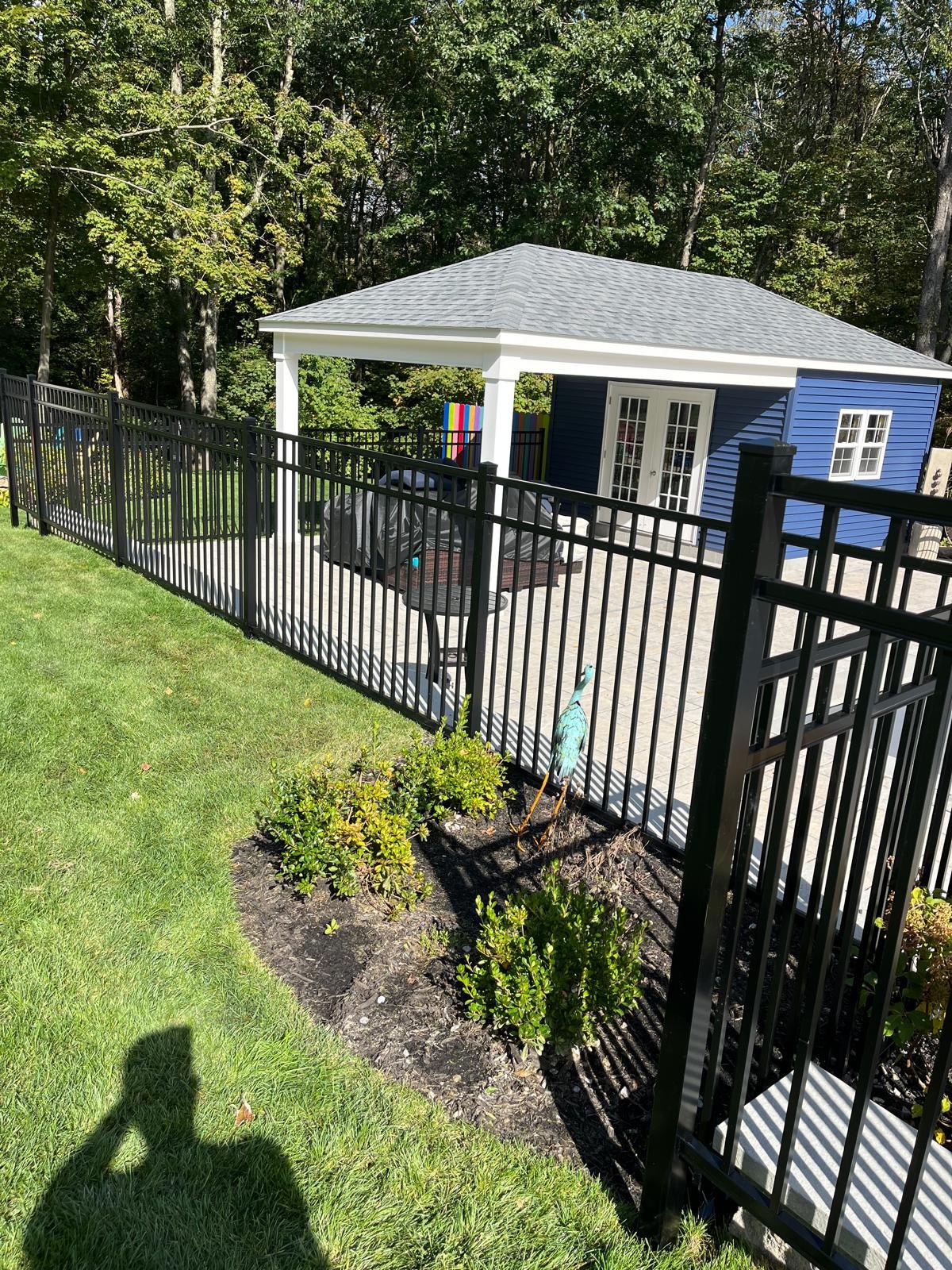 Black ornamental aluminum fence installed along a lawn by New Horizon Fence